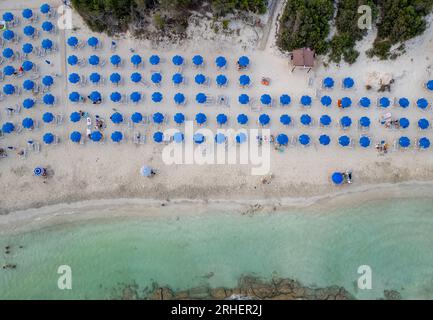 Drone aerial of tropical sandy beach holiday resort with beach umbrellas and people swimming. Summer vacations. Landa beach Ayia Napa Cyprus Stock Photo