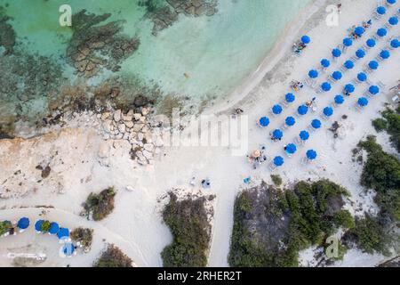 Drone aerial of tropical sandy beach holiday resort with beach umbrellas and people swimming. Summer vacations. Landa beach Ayia Napa Cyprus Stock Photo