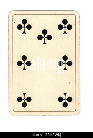 An antique seven of clubs playing card on a white background. Stock Photo