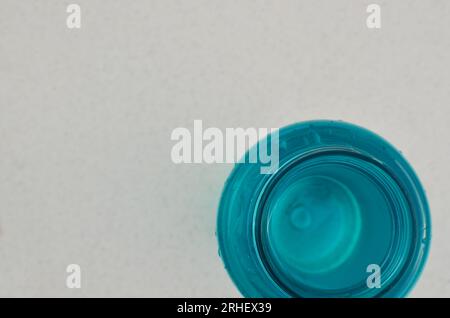Detail of a bottle of blue water, the essence of hydration for determined athletes. Stock Photo