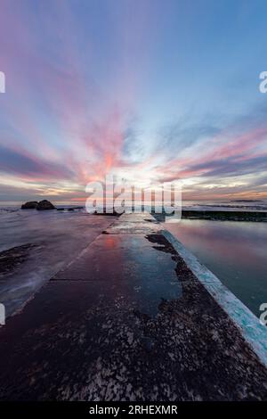 Ocean landcape scenery photograph of the Atlantic ocean in camps bay Cape Town South Africa with beautiful pink clouds, tourist destination Stock Photo