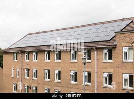 A large array of solar panels on the roof of student accommodation at a university, England, UK Stock Photo