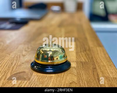 Ring for service bell on a wooden table Stock Photo