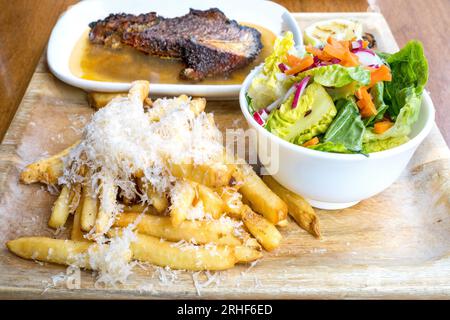 Farm to Table, Beef Roast and French Fries with graded parmesan, Salat,  Calgary Downtown Stampede Festival Banff National Park, Canadian Rockies, Alb Stock Photo