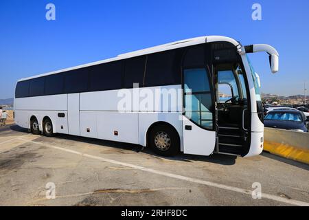 Big white passenger bus in the parking lot Stock Photo