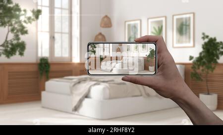 Hand holding smart phone, AR application, simulate furniture and interior design products in real home, architect designer concept, blur background, w Stock Photo