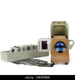 Old slide projector and set of slides isolated on white background. Retro equipment. Free space for text. Stock Photo