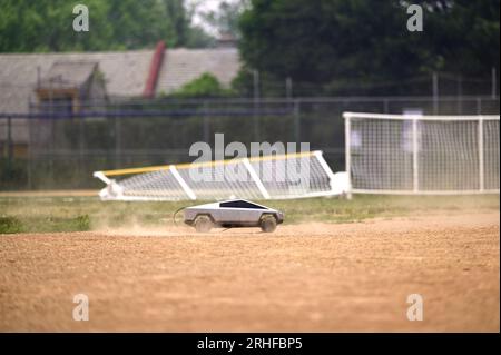 RC Cybertruck stirs dust on a baseball infield, its aimless path a reflection of uncertainty, a metaphor resonating amidst ongoing economic challenges Stock Photo