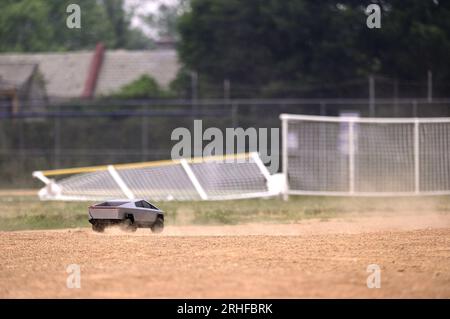 RC Cybertruck stirs dust on a baseball infield, its aimless path a reflection of uncertainty, a metaphor resonating amidst ongoing economic challenges Stock Photo