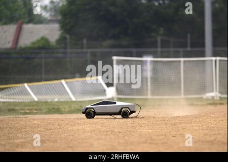 RC Cybertruck stirs dust on a baseball infield, its aimless path a reflection of uncertainty, a metaphor resonating amidst ongoing economic challenges Stock Photo