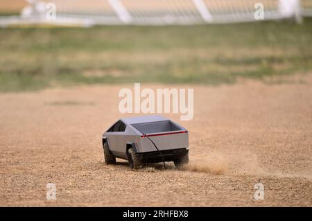 RC Cybertruck stirs dust on a baseball infield, its aimless path a reflection of uncertainty, a metaphor resonating amidst ongoing economic challenges Stock Photo