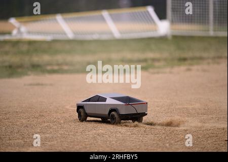 RC Cybertruck stirs dust on a baseball infield, its aimless path a reflection of uncertainty, a metaphor resonating amidst ongoing economic challenges Stock Photo