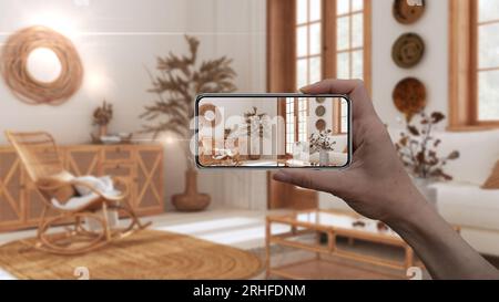 Hand holding smart phone, AR application, simulate furniture and interior design products in real home, architect designer concept, blur background, b Stock Photo