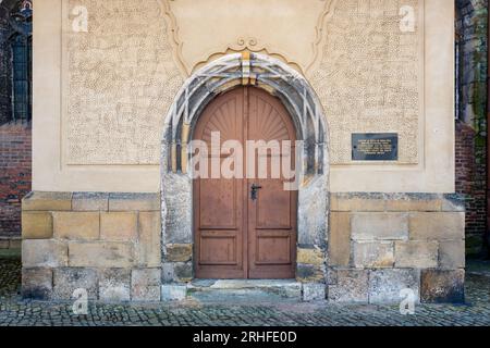 Church of St.Giles in the town of Nymburk, Czechia.Portal permanently sealed since 1634 when troops of Sweden and Saxony massacred hiding townspeople. Stock Photo