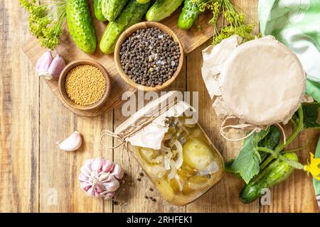 Healthy homemade fermented food. Salted pickled cucumbers salad preserved canned in glass jar. Home economics, autumn harvest preservation. View from Stock Photo