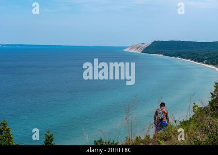 Hiker at Sleeping Bear Dunes National Seashore with Lake Michigan from Empire Bluffs, Michigan Stock Photo