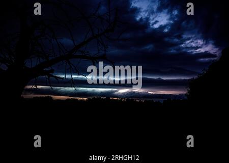 Altenstein, Germany. 16th Aug, 2023. Lightning illuminates the sky on the horizon. From Altenstein (Haßberge district, Lower Franconia), the thunderstorm front moving across northern Bavaria and southern Thuringia was clearly visible. Credit: Pia Bayer/dpa/Alamy Live News Stock Photo