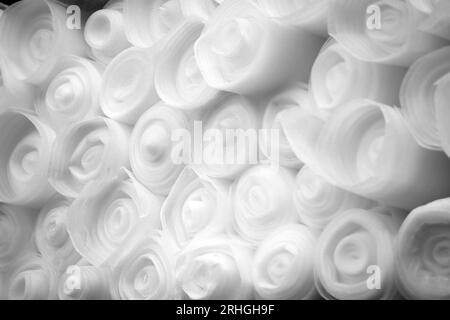 Rolls of the industrial polypropylene. Foamed synthetic material rolled up on the shelf of a construction store. Stock Photo