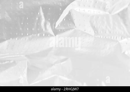 Abstract background of white wrinkled plastic cellophane film texture. Glued paper or fabric mockup. Stock Photo