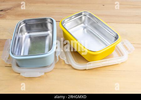 Metal empty stillness steel lunch boxes with on a wooden background Stock Photo