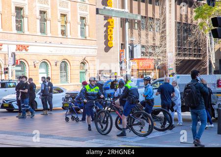 Sydney police officers including officers riding bicycles monitor a protest march in Sydney city centre,NSW,Australia Stock Photo