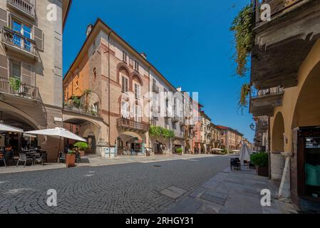 Cuneo, Piedmont, Italy - August 16, 2023: Cityscape on Roma Street main pedestrian cobblestone street with Ancient buildings decorated and with arcade Stock Photo