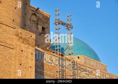 View of the scaffolding crane, part of a renovation, preservation project on the roof. At the Timirud style, Silk Road era iconic site, the Khoja Ahme Stock Photo