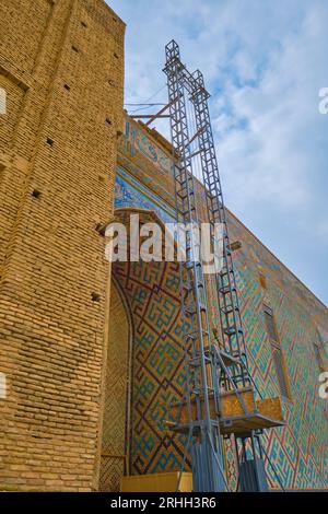 View of the scaffolding crane, part of a renovation, preservation project on the roof. At the Timirud style, Silk Road era iconic site, the Khoja Ahme Stock Photo