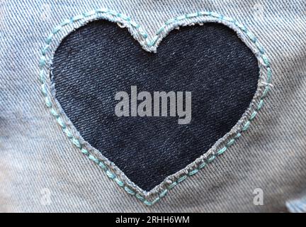 heart shaped patch on jeans fabric Stock Photo