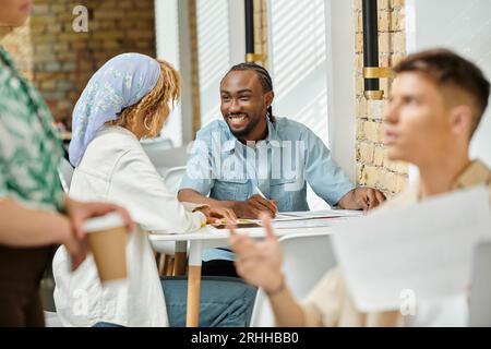 cheerful african american coworkers discussing project over graphs, coworking, start up, ideas Stock Photo