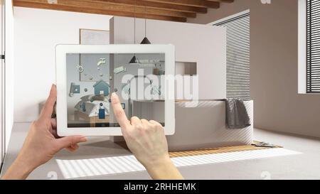 Smart remote home control system on a digital tablet. Device with app icons. Japandi minimal bathroom with bathtub in the background, minimal interior Stock Photo
