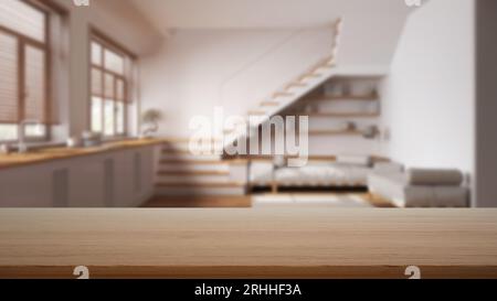 Empty wooden table, desk or shelf with blurred view of minimal white kitchen and living room with sofa and staircase, modern interior design concept Stock Photo