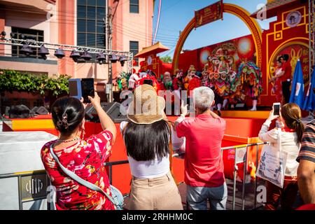 Thai people and tourists busily photograph the dance and singing show celebrating Chinese New Year on Yaowarat Rd. China Town, Bangkok Thailand. Stock Photo