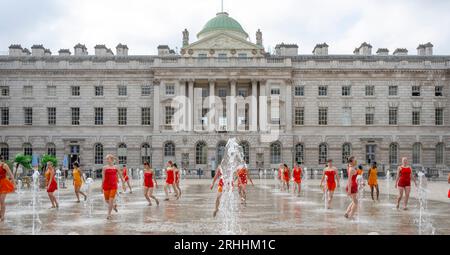 Somerset House, London, UK. 17 August 2023. 22 all-female dancers in vivid orange costumes designed by Ursula Bombshell dance in the fountains at Somerset House in a dress rehearsal for Shobana Jeyasingh’s Counterpoint. There areeight performances of Counterpoint over the weekend of 19-20 August 2023, part of Somerset House’s Summer in the Courtyard and Westminster City Council's Inside Out festival. Credit: Malcolm Park/Alamy Stock Photo