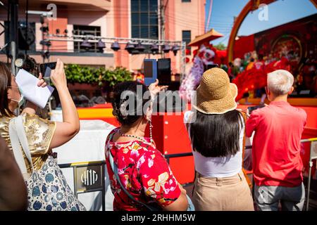 Thai people and tourists busily photograph the dance and singing show celebrating Chinese New Year on Yaowarat Rd. China Town, Bangkok Thailand. Stock Photo