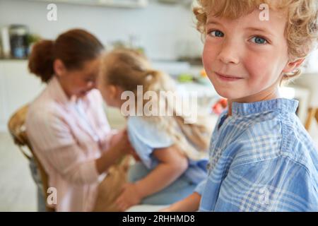 Side view portrait of smiling boy with family having fun at home Stock Photo