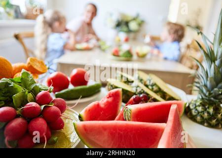 Fresh watermelon slices with fruits and vegetables on table at home Stock Photo