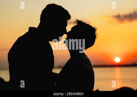 silhouette of loving couple on sunset on beach. High quality photo Stock Photo