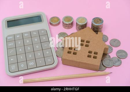 Money coins and calculator on pastel pink background Stock Photo
