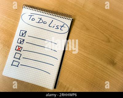 to do list checklist hand written on notepad paper lay on wooden table. . High quality photo Stock Photo