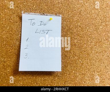 to do list hand written on notepad paper sheet and pinned on cork board. High quality photo Stock Photo