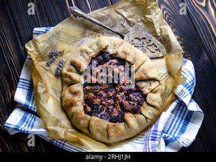 Food photography of dessert course with delicious plums, pie crust in vintage style Stock Photo