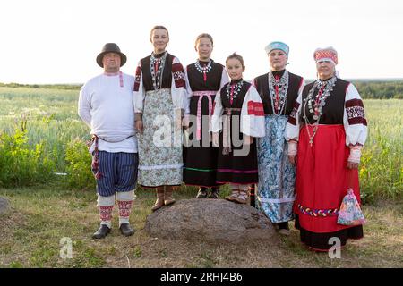 Family members in traditional seto estonian folk costumes dressed for celebrating estonian national holiday called Jaanipaev or leedopaev, Estonia Stock Photo