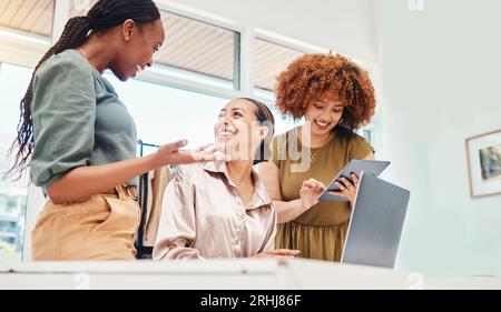 Team, talking and employees working on tech in office with creative, ideas for planning a digital marketing strategy on pc or tablet. Online Stock Photo