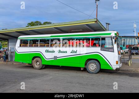 Nadi, Fiji - 23 May 2023: Indigenous Fijian people travel by bus. In Fiji every town and village has a bus stop since this is still the most common fo Stock Photo