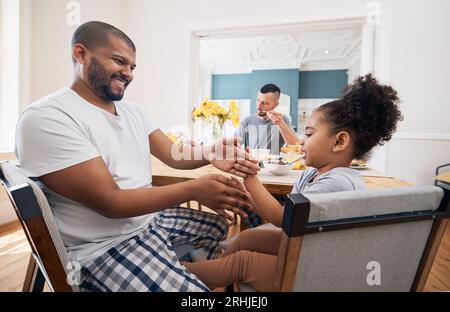 Gay couple, breakfast and happy family child playing, bond and have fun with queer dad, bisexual papa or home parents. Morning, adoption or homosexual Stock Photo
