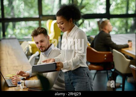 Diverse colleagues talking discussing business project in office Stock Photo