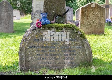 Headstone of author Arthur Conan Doyle, famous writer and creator of Sherlock Holmes books, All Saints Churchyard in Minstead, Hampshire, England, UK Stock Photo