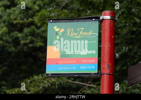 Sign at bus stop - New Forest tour bus stops here, Hampshire, England, UK Stock Photo