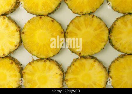 Pineapple juicy yellow slices on a white background. Top view. Stock Photo